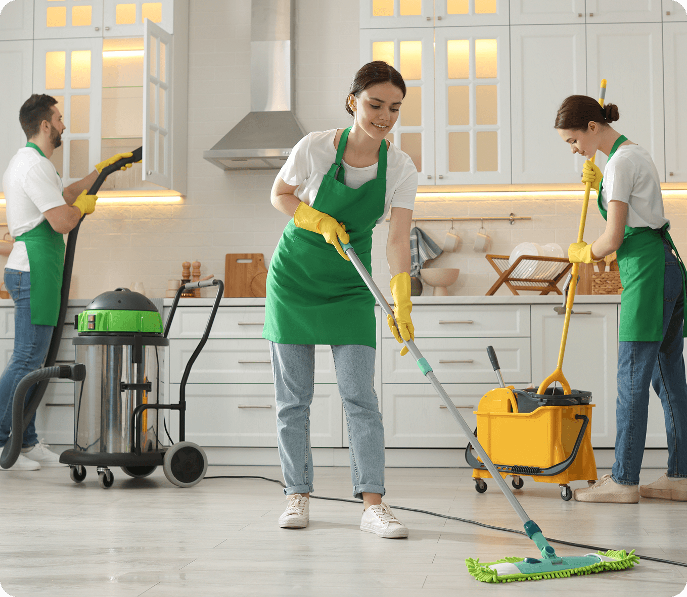 Cleaning team working in modern kitchen.